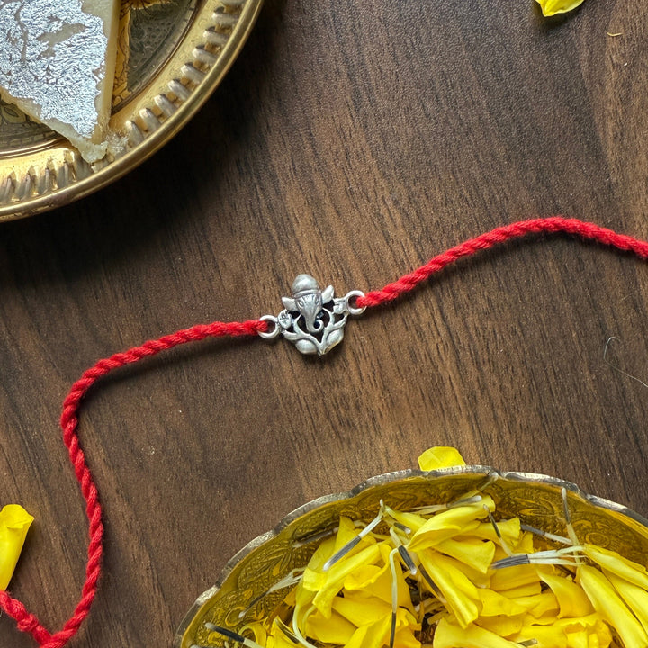 Rakhi with a pumpkin and yellow leaves on a wooden surface